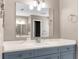 Bathroom vanity with white countertop, blue cabinets, and chrome faucet at 3654 Beneraid St, Land O Lakes, FL 34638