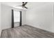 Bright bedroom with grey hardwood flooring, window, and ceiling fan at 3654 Beneraid St, Land O Lakes, FL 34638