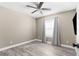 Cozy bedroom with neutral paint, wood floors, ceiling fan, baseboard trim, and natural light at 3654 Beneraid St, Land O Lakes, FL 34638