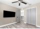Bedroom with gray walls, wood-look floors, ceiling fan and large closet at 3654 Beneraid St, Land O Lakes, FL 34638