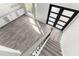 Bright and airy foyer featuring hardwood floors, staircase, and a modern black door at 3654 Beneraid St, Land O Lakes, FL 34638