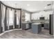 Modern kitchen with gray cabinets, stainless steel appliances, an island, and decorative backsplash at 3654 Beneraid St, Land O Lakes, FL 34638
