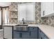 Kitchen featuring stainless sink, stone countertops, and contrasting backsplash at 3654 Beneraid St, Land O Lakes, FL 34638