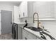 Laundry room features stone countertops, a gold faucet, and a sink at 3654 Beneraid St, Land O Lakes, FL 34638