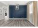 Living room featuring modern hardwood floors and a decorative blue accent wall at 3654 Beneraid St, Land O Lakes, FL 34638