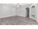 Spacious and bright living room features wood floors, neutral paint, recessed lights, and an archway at 3654 Beneraid St, Land O Lakes, FL 34638