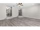 Spacious living room with hardwood floors, ceiling fan and easy access to other rooms at 3654 Beneraid St, Land O Lakes, FL 34638
