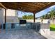 Spacious outdoor kitchen featuring a built-in grill, refrigerator, and sink, ideal for backyard entertaining at 3654 Beneraid St, Land O Lakes, FL 34638