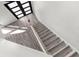 Modern staircase with wood stairs and black framed window at 3654 Beneraid St, Land O Lakes, FL 34638
