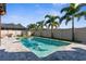 A beautiful backyard swimming pool is surrounded by brick pavers, lush landscaping, and privacy fencing at 3654 Beneraid St, Land O Lakes, FL 34638