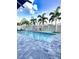 Sparkling swimming pool with a paver patio and lush palm trees, ideal for relaxation at 3654 Beneraid St, Land O Lakes, FL 34638