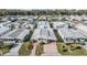 Aerial view of a well-maintained manufactured home community with lush landscaping at 36745 Kimela Ave, Zephyrhills, FL 33542