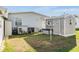 Cozy backyard featuring a storage shed, personal items, and grassy area at 36745 Kimela Ave, Zephyrhills, FL 33542