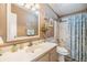 Traditional bathroom with tub, shower, seashell-themed shower curtain, and large vanity mirror at 36745 Kimela Ave, Zephyrhills, FL 33542