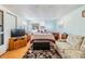 Bright, comfortable bedroom featuring wooden floors, dresser, and decor at 36745 Kimela Ave, Zephyrhills, FL 33542