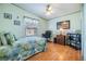 Comfortable bedroom with hardwood floors, ceiling fan, and an American flag decoration at 36745 Kimela Ave, Zephyrhills, FL 33542