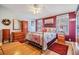 Cozy bedroom with decorative bed frame, hardwood floors, and matching dresser set at 36745 Kimela Ave, Zephyrhills, FL 33542
