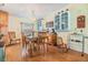 Charming dining room with hardwood floors, chandelier, and views of the kitchen and living space at 36745 Kimela Ave, Zephyrhills, FL 33542