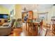 Open-concept dining room with hardwood floors and a chandelier, flowing into the kitchen and living area at 36745 Kimela Ave, Zephyrhills, FL 33542