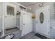 Accessible entryway with a lift, tiled flooring, and decorative doors with a welcome sign at 36745 Kimela Ave, Zephyrhills, FL 33542