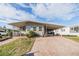 Charming single-story home featuring a covered carport and well-maintained front yard at 36745 Kimela Ave, Zephyrhills, FL 33542