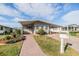Charming single-story home featuring a covered carport, brick driveway and manicured lawn at 36745 Kimela Ave, Zephyrhills, FL 33542