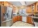 Charming kitchen with wooden cabinets, granite countertops, and stainless-steel appliances at 36745 Kimela Ave, Zephyrhills, FL 33542