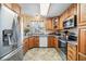 Charming kitchen with wooden cabinets, granite countertops, and stainless-steel appliances at 36745 Kimela Ave, Zephyrhills, FL 33542