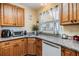 Charming kitchen featuring a large window, granite counters, and wooden cabinetry at 36745 Kimela Ave, Zephyrhills, FL 33542