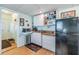 View of the kitchenette area, featuring a small sink, cabinets, and a refrigerator at 36745 Kimela Ave, Zephyrhills, FL 33542