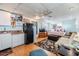 Open-concept living room with kitchenette, ceiling fan, and cozy decor at 36745 Kimela Ave, Zephyrhills, FL 33542