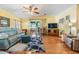 Bright living room with hardwood floors, a ceiling fan, sliding doors, and comfortable seating at 36745 Kimela Ave, Zephyrhills, FL 33542