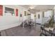Covered patio area with tiled flooring, ceiling fan, and outdoor furniture seating arrangement at 36745 Kimela Ave, Zephyrhills, FL 33542