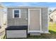 Utility shed in backyard with access door and step at 36745 Kimela Ave, Zephyrhills, FL 33542