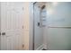 Clean shower with frosted glass doors and shower head with shelving at 36745 Kimela Ave, Zephyrhills, FL 33542