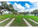 Outdoor shuffleboard courts with shelter, benches, a pond and a manicured lawn at 36745 Kimela Ave, Zephyrhills, FL 33542