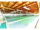 Shuffleboard courts featuring wooden ceiling, benches, overhead lighting and flags at each end at 36745 Kimela Ave, Zephyrhills, FL 33542