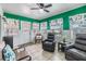 Bright sunroom with tile flooring, ceiling fan, and large windows at 36745 Kimela Ave, Zephyrhills, FL 33542