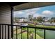 Scenic balcony view overlooking a tranquil pond and common area with gazebo at 4112 Ashford Green Pl # I203, Tampa, FL 33613