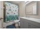 Cozy bathroom with a tub featuring a playful turtle-themed shower curtain and a modern vanity at 4112 Ashford Green Pl # I203, Tampa, FL 33613