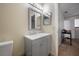 Bright bathroom with a modern gray vanity, white countertop and a framed mirror at 4112 Ashford Green Pl # I203, Tampa, FL 33613