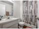 Bathroom with a patterned shower curtain, classic sink and a wood-look floor at 4112 Ashford Green Pl # I203, Tampa, FL 33613