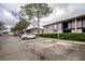 Exterior view of a multi-unit building with manicured hedges and ample parking spaces at 4112 Ashford Green Pl # I203, Tampa, FL 33613