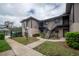 Exterior of building featuring stairs to upper level and garden area at 4112 Ashford Green Pl # I203, Tampa, FL 33613