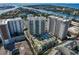 Aerial shot of luxury condo buildings features lush landscaping, a sparkling pool, and stunning waterfront views at 450 Knights Run Ave # 1805, Tampa, FL 33602