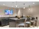 Bar area with dark grey cabinets, pendant lighting, a sink and bar seating at 450 Knights Run Ave # 1805, Tampa, FL 33602