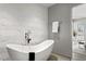 Elegant bathroom featuring a freestanding tub and a modern, geometric tiled wall at 450 Knights Run Ave # 1805, Tampa, FL 33602