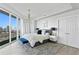 Bright and airy bedroom with city views featuring a modern aesthetic and balcony access at 450 Knights Run Ave # 1805, Tampa, FL 33602