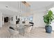 Bright dining area featuring a modern chandelier, glass table, and natural light at 450 Knights Run Ave # 1805, Tampa, FL 33602