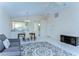 Spacious living area flowing into the kitchen, featuring neutral tones, tile floors, and bright lighting at 4772 Silver Cir, Zephyrhills, FL 33541